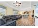 Open floor plan connecting the living room to the kitchen with a large sectional couch at 2417 Cumberland Cliff Dr, Ruskin, FL 33570