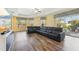 Spacious living room with a black sectional couch and sliding door access to the pool area at 2417 Cumberland Cliff Dr, Ruskin, FL 33570