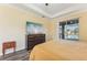 Main bedroom features an entertainment center and a sliding glass door to the pool at 2417 Cumberland Cliff Dr, Ruskin, FL 33570