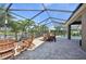 Inviting screened lanai featuring a dining area overlooking the pool and serene water views, ideal for outdoor enjoyment at 2417 Cumberland Cliff Dr, Ruskin, FL 33570