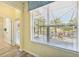 Patio view seen through the large window, featuring wooden floors and natural light at 2417 Cumberland Cliff Dr, Ruskin, FL 33570