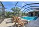 Relaxing screened pool area with lounge chairs and a beautiful view, perfect for enjoying the Florida sunshine at 2417 Cumberland Cliff Dr, Ruskin, FL 33570