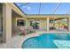 Backyard pool with patio, chairs and beautiful lush tropical landscaping, perfect for outdoor living at 2417 Cumberland Cliff Dr, Ruskin, FL 33570