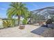 Screened patio area features a pool, a view of the lake, and comfortable seating area at 2417 Cumberland Cliff Dr, Ruskin, FL 33570
