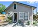 Rear exterior elevation featuring a well-lit entry with manicured landscaping and updated siding at 2435 4Th N Ave, St Petersburg, FL 33713