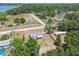 Aerial view of the home with a fenced yard, amid mature trees in the lakeside community, offering privacy and natural beauty at 25126 Huston St, Brooksville, FL 34601