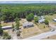 Aerial view of a home surrounded by lush trees in a tranquil neighborhood at 25126 Huston St, Brooksville, FL 34601