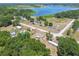 Stunning aerial view of homes near a lake with lush trees and greenery, offering a serene, nature-filled setting at 25126 Huston St, Brooksville, FL 34601