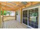 Charming wooden back porch with railings and sliding glass doors, perfect for outdoor relaxation at 25126 Huston St, Brooksville, FL 34601