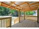 Inviting wooden back porch, offering an ideal spot for enjoying the surrounding greenery at 25126 Huston St, Brooksville, FL 34601