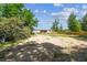 Partially cleared backyard, providing privacy with a newly installed wooden fence and mature trees at 25126 Huston St, Brooksville, FL 34601