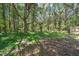 Wooded lot view, bordered by a wooden fence on the side boundary at 25126 Huston St, Brooksville, FL 34601