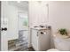 Bathroom with a modern vanity, granite countertop, black hardware, and wood grain flooring at 25126 Huston St, Brooksville, FL 34601