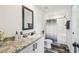 Modern bathroom features a granite-topped vanity and a shower-tub combo with stylish shower curtain at 25126 Huston St, Brooksville, FL 34601
