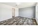 An empty bedroom with wood grain flooring, neutral wall colors, and bright lighting at 25126 Huston St, Brooksville, FL 34601