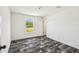 Bright bedroom with dark wood flooring, window views, and white walls, creating a serene space at 25126 Huston St, Brooksville, FL 34601