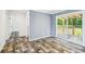 Bedroom features a sliding glass door leading to a deck, wood grain flooring, and neutral wall colors at 25126 Huston St, Brooksville, FL 34601