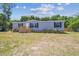 Single-story home displays a neatly kept lawn, complemented by a wooden fence and a welcoming entrance at 25126 Huston St, Brooksville, FL 34601
