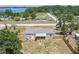 Aerial of a charming home featuring a spacious yard, wooden fence, and a welcoming covered porch, ideal for outdoor enjoyment at 25126 Huston St, Brooksville, FL 34601