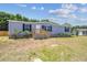 Well-kept single-story home boasts a manicured lawn and inviting entrance, enhanced by lush landscaping at 25126 Huston St, Brooksville, FL 34601