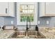 Close-up of a modern kitchen sink featuring granite countertops and stainless steel hardware at 25126 Huston St, Brooksville, FL 34601