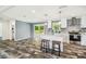Modern kitchen boasts a center island, white cabinetry, and stainless steel appliances at 25126 Huston St, Brooksville, FL 34601