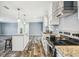 Modern kitchen featuring an island and stainless steel appliances in an open-concept space at 25126 Huston St, Brooksville, FL 34601