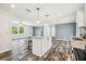 A well-lit kitchen area features a central island, recessed lighting, and open access to the living space at 25126 Huston St, Brooksville, FL 34601