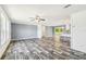 A spacious living room boasts wood-look floors and an open layout to the kitchen at 25126 Huston St, Brooksville, FL 34601