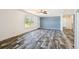 Open-plan living room with wood-look flooring and large windows providing natural light at 25126 Huston St, Brooksville, FL 34601