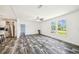 Bright living room featuring wood-look floors and large windows with backyard views at 25126 Huston St, Brooksville, FL 34601