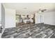 Open-concept living room features modern flooring, neutral walls, and seamlessly connects to a spacious kitchen at 25126 Huston St, Brooksville, FL 34601
