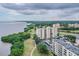 Scenic aerial view of a bayfront condo complex featuring lush greenery and stunning water views at 2617 Cove Cay Dr # 401, Clearwater, FL 33760