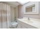 Bathroom featuring a vanity with a cream-colored sink, framed mirror and a shower tub combo at 2617 Cove Cay Dr # 401, Clearwater, FL 33760