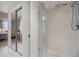 Modern bathroom showcases a glass-enclosed shower with white tile and a view into an adjacent bedroom at 2617 Cove Cay Dr # 401, Clearwater, FL 33760