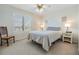 Cozy bedroom with plantation shutters, a ceiling fan, neutral carpet and soft, natural light at 2617 Cove Cay Dr # 401, Clearwater, FL 33760