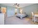 Well lit bedroom with carpet, desk, and view to connected bathroom at 2617 Cove Cay Dr # 401, Clearwater, FL 33760