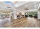 Spacious clubhouse featuring an island bar, modern kitchen, multiple seating areas, and natural light at 2617 Cove Cay Dr # 401, Clearwater, FL 33760
