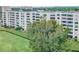 Multi-story condo building with well-maintained lawn and mature trees at 2617 Cove Cay Dr # 401, Clearwater, FL 33760