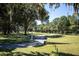 Picturesque golf course path lined with mature trees and lush green grass at 2617 Cove Cay Dr # 401, Clearwater, FL 33760
