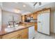 Open kitchen featuring a breakfast bar, bright lighting, and modern appliances at 2617 Cove Cay Dr # 401, Clearwater, FL 33760