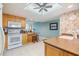 Bright open kitchen with wooden cabinets, white appliances and eating area at 2617 Cove Cay Dr # 401, Clearwater, FL 33760