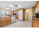 Open kitchen design featuring tile floors, wood cabinets and modern appliances at 2617 Cove Cay Dr # 401, Clearwater, FL 33760