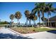 Outdoor dining area overlooking the water, with tables, chairs, palm trees, and manicured landscaping at 2617 Cove Cay Dr # 401, Clearwater, FL 33760