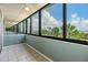Enclosed sunroom with tile flooring and panoramic views of the outdoors and water at 2617 Cove Cay Dr # 401, Clearwater, FL 33760