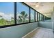 Spacious sunroom featuring tile floors, multiple windows, and serene water views at 2617 Cove Cay Dr # 401, Clearwater, FL 33760