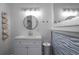Contemporary bathroom with a round mirror, sleek vanity, and decorative wall texture at 267 Broad St, Brooksville, FL 34604