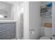 Cozy bathroom featuring decorative wall panel, shower with marble-look tile, and built-in shelving for towel storage at 267 Broad St, Brooksville, FL 34604