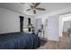 Bedroom with black comforter, ceiling fan, an exercise bike, and wood-look floors at 267 Broad St, Brooksville, FL 34604