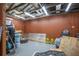 A workshop area in the garage featuring an open rafter ceiling, concrete floors, and plenty of room for projects at 267 Broad St, Brooksville, FL 34604